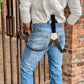 Back view of Espresso Brown Linen Button-On Suspenders with Black Leather Attachments, featuring a handcrafted veg-tan leather back patch, styled with classic denim and a vintage white Henley – Handmade by Stratton Suspender Co. for a heritage menswear look.