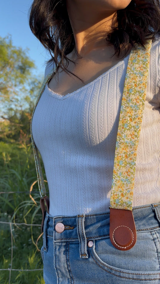 Floral women’s magnetic clasp suspenders with leather tabs, handmade to order and styled with blue jeans.