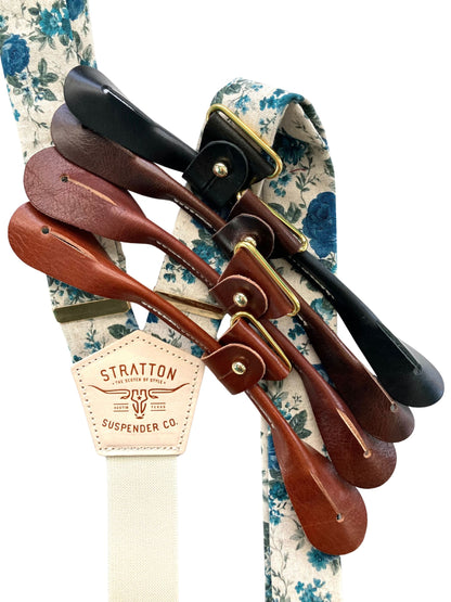 Handcrafted Heritage Blue Floral Linen Button-On Suspenders with premium leather button attachments in black, chocolate, cognac, and tan. These vintage-inspired suspenders by Stratton Suspender Co. are designed for weddings, groomsmen, and timeless menswear, offering a refined yet rustic aesthetic with superior craftsmanship.