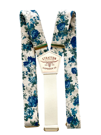 Heritage blue floral linen suspenders with a cream twill elastic back strap and brass hardware. Handmade button-on suspenders for weddings, groomsmen, and vintage menswear. Ethically crafted with premium materials for a timeless, elegant look.