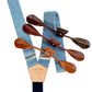 Handmade light blue linen suspenders with navy elastic back strap and full-grain veg-tan leather button attachments in whiskey cognac, chocolate, and dark honey tan. Ethically made by Stratton Suspender Co. in Texas. Ideal for weddings, groomsmen, and heritage menswear.