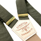 Close-up of olive green linen button-on suspenders with a taupe back strap, featuring full-grain leather detailing, premium brass adjusters, and handcrafted stitching. A refined, vintage-inspired accessory perfect for groomsmen, weddings, and timeless menswear.