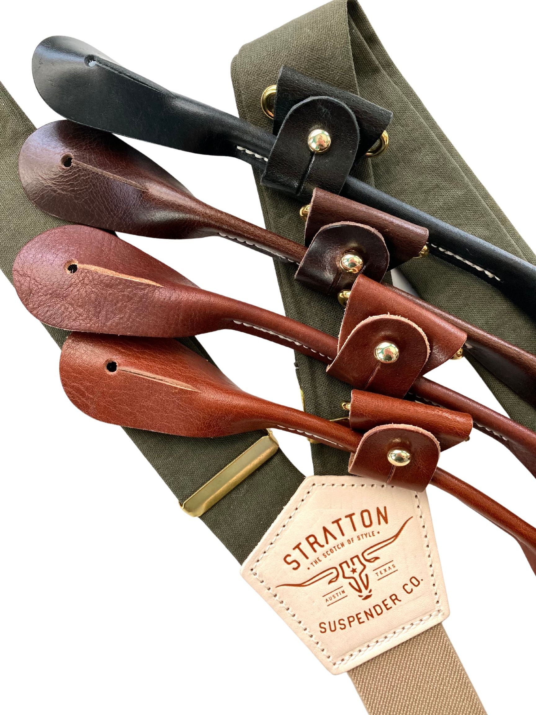 Close-up of olive green linen suspenders with full-grain leather button attachments in black, chocolate, cognac, and tan. Features premium brass adjusters, taupe back strap, and heritage-quality craftsmanship. A timeless accessory for weddings, groomsmen, and refined menswear.