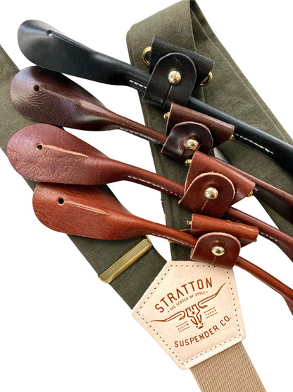 Close-up of olive green linen suspenders with full-grain leather button attachments in black, chocolate, cognac, and tan. Features premium brass adjusters, taupe back strap, and heritage-quality craftsmanship. A timeless accessory for weddings, groomsmen, and refined menswear.