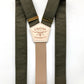 Flat-lay of olive green linen suspenders with a taupe back strap, brass hardware, and premium craftsmanship. Features a hand-stitched leather back patch and vintage-inspired design. Ideal for weddings, groomsmen, and heirloom menswear.