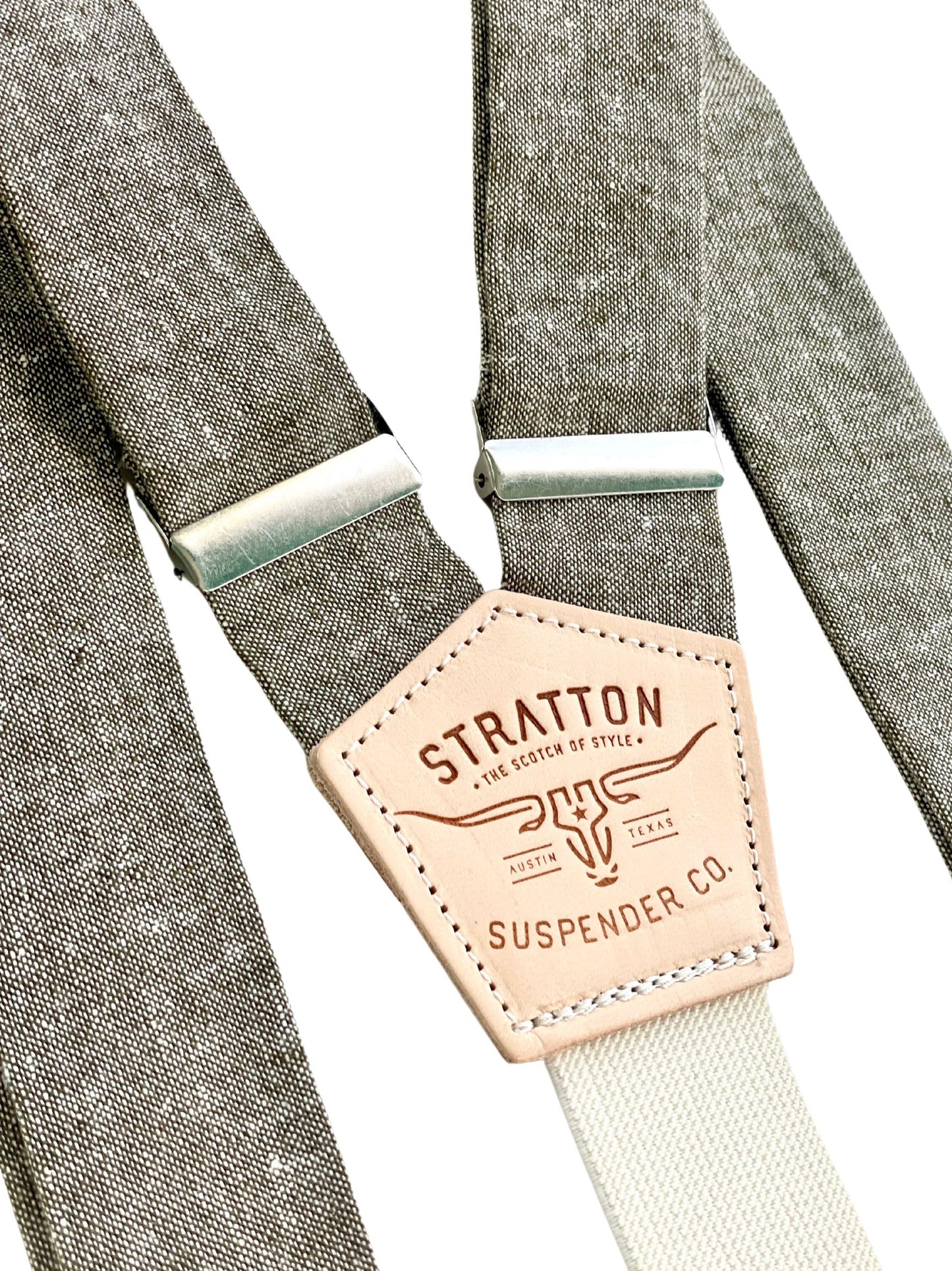 Stratton Suspender Co. features the olive green linen suspenders on veg tan shoulder leather with cream colored elastic back strap for the Fall 2022 suspenders collection