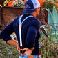 Back view of a groom wearing Sapphire Blue Floral wedding suspenders at a rustic Texas wedding. These vintage button-on suspenders feature a blue floral linen strap, a classic white elastic back, and full-grain leather button-on attachments for a tailored, heritage menswear look. Designed for grooms, groomsmen, and rustic wedding themes, offering a superior alternative to clip-ons. Perfect for Western weddings, boho wedding attire, and country-chic styling.