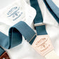 Teal blue linen button-on suspenders with a cream back strap, handcrafted for weddings, groomsmen, and vintage menswear. Premium leather attachments and timeless design for formal and rustic weddings.