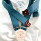 Handmade teal linen button-on suspenders with a cream back strap and chocolate leather button attachments. A premium wedding accessory for groomsmen, rustic weddings, and classic menswear.