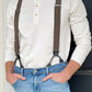 Man wearing a vintage long sleeve Henley shirt in off-white, paired with vintage brown button-on suspenders and light wash jeans. Ethically made in the USA, this heritage American menswear look blends rustic charm with timeless style. Ideal for casual, rugged outfits and classic vintage-inspired fashion.