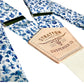 Handmade sapphire blue floral wedding suspenders featuring delicate vintage-inspired floral fabric, full-grain veg-tan leather button-on attachments, and a woven elastic back strap for comfort. Designed for grooms, groomsmen, and vintage menswear enthusiasts, these suspenders blend heritage craftsmanship with modern elegance. Ideal for spring and summer weddings, rustic wedding themes, and timeless formal attire.