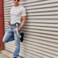 Man wearing black linen suspenders with a vintage white tee and light-wash jeans, styled for modern Western menswear. Effortless Austin Texas street style with rugged heritage American craftsmanship. Perfect for casual menswear and laid-back charm.