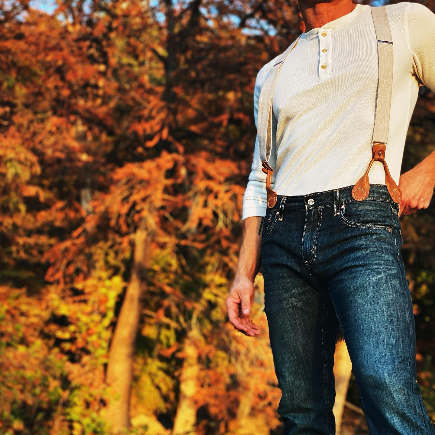 Beige wedding suspenders with leather magnetic clasps worn with vintage Henley shirt and vintage levi's with Texas Hill Country wedding backdrop