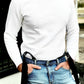 Model in white thermal shirt and blue jeans wearing black linen suspenders with button-on leather tabs, handmade in Texas for rustic weddings and timeless men's style.