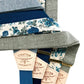 Assorted blue and sage green suspenders with gold adjusters and floral patterns, handmade for weddings, groomsmen attire, and vintage-inspired formalwear.