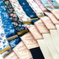 A lineup of bold floral linen suspenders by Stratton Suspender Co., showcasing a variety of prints in navy, black, ivory, and pastels—ideal for weddings, formal events, or standout groomsmen looks.