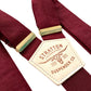 Rustic wedding suspenders in deep Bordeaux with gold adjusters and burgundy elastic—vintage-inspired button-on style for groomsmen.