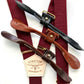 Bordeaux linen wedding suspenders with gold hardware shown with four leather button-on tab options: black, chocolate, cognac, and tan.