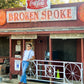 Man wearing Stratton Suspender Co. denim blue linen suspenders with button-on leather ends, standing outside the iconic Broken Spoke dancehall on South Lamar in Austin, Texas.