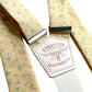 Close-up of Butter Yellow Victorian Floral Wedding Suspenders by Stratton Suspender Co., featuring delicate pink and green floral patterns with handcrafted leather detailing. Perfect for vintage-inspired weddings and garden-themed ceremonies.