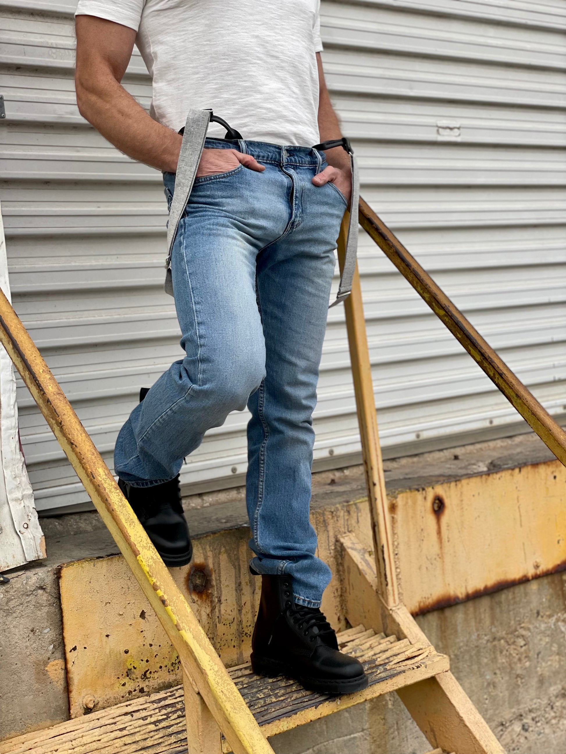 Charcoal linen button-on suspenders with black leather details, worn with vintage Levi’s, a white fitted t-shirt, and black boots. Handmade in the USA, perfect for groomsmen gifts, rustic weddings, and classic heritage menswear.