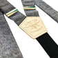 Close-up of charcoal linen suspenders with natural leather back patch and silver-tone adjusters, handmade in Texas by Stratton Suspender Co.—ideal for rustic weddings and timeless men's fashion.