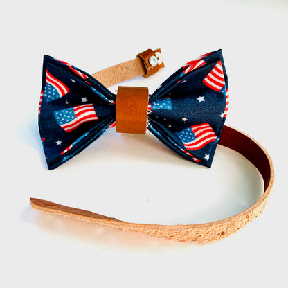 Special edition kids' bow tie featuring an American flag print, pre-tied with a tan leather center and natural leather strap—perfect for Independence Day.