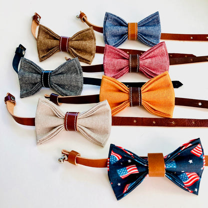 Children’s pre-tied bow tie collection in assorted linen colors with leather center wraps and adjustable straps, displayed side by side.