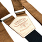 Close-up of handmade cinnamon brown linen button-on suspenders with premium full-grain leather back patch and antique brass adjusters, perfect for rustic weddings, groomsmen outfits, or vintage-inspired menswear.