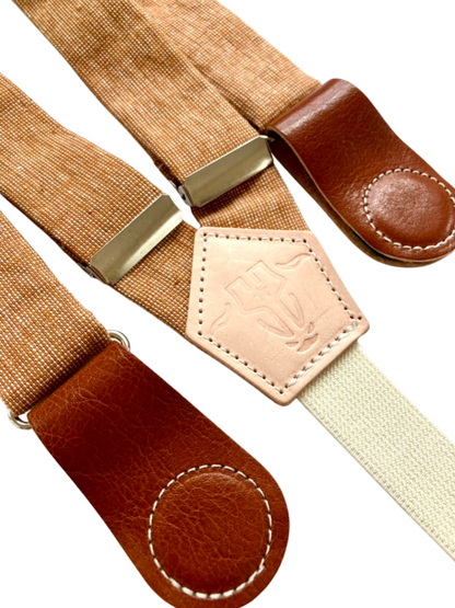 Close-up of Cinnamon Pecan women’s suspenders, vintage hand-woven linen straps with Cognac leather magnetic clasps, handmade in Texas.