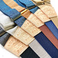 Flat lay of custom linen wedding suspenders featuring personalized leather back patches stamped “Austin Post – Handmade in USA,” designed for groomsmen gifts, rustic wedding parties, and vintage-inspired formalwear.