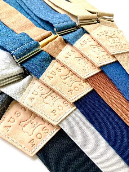 Custom leather suspenders featuring “Austin Post” branded back patches by Stratton Suspender Co. Showcasing personalized logo options for weddings, events, and branded menswear. Handmade in Texas using premium linen and leather.