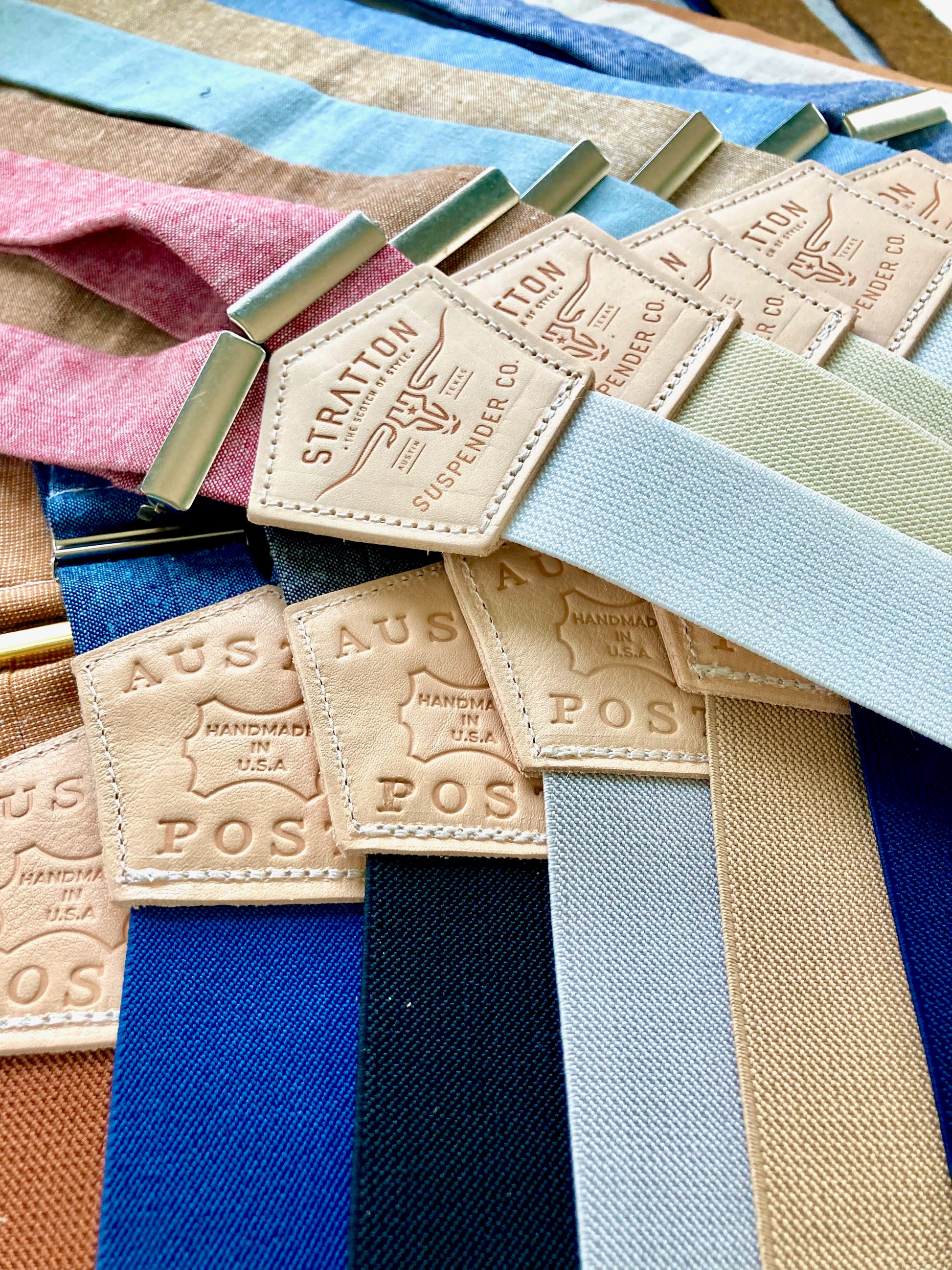 Custom suspenders order for Post Malone featuring Stratton and Austin Post branded leather back patches—handmade in the USA with durable twill straps in assorted earth tones, ideal for weddings, gifts, and custom menswear.