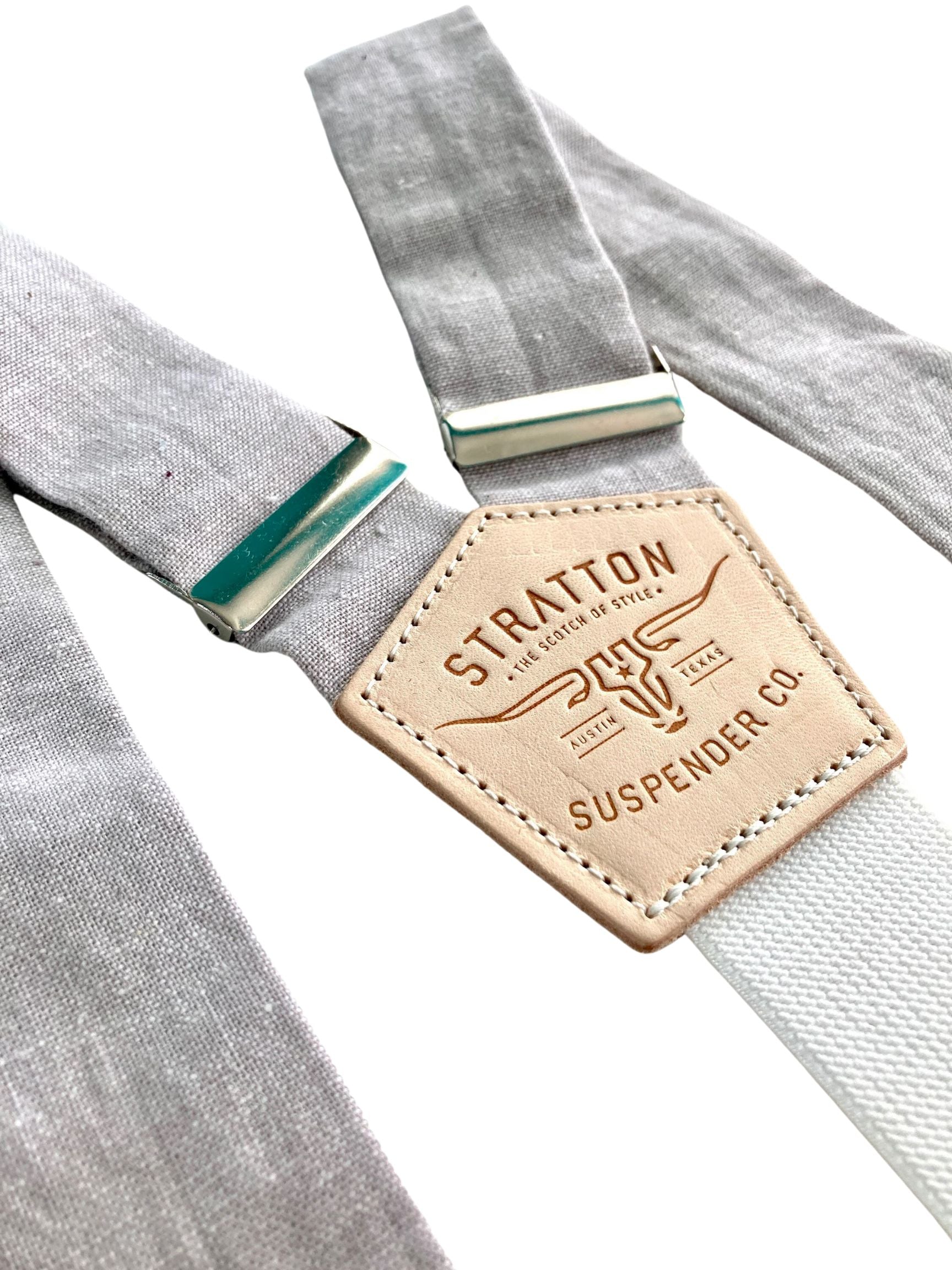 Close-up of dove gray linen suspenders featuring premium natural leather back patch and silver-tone adjusters, handmade in Texas for groomsmen and formal events.