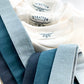 Close-up of linen suspenders in dusty blue, teal, and slate tones, highlighting subtle shade differences for groomsmen or wedding party styling.