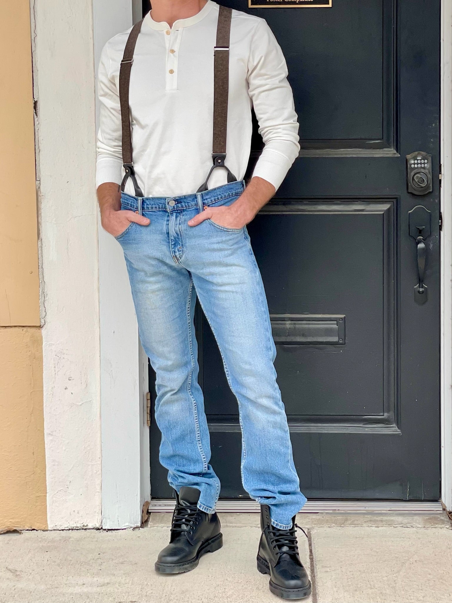 Espresso brown button-on suspenders with black leather accents styled with a vintage cream Henley shirt from Stratton Suspender Co., shown worn with jeans and boots—classic men’s outfit for weddings, groomsmen, or everyday rugged fashion.