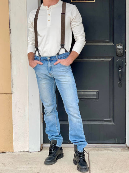 Espresso brown button-on suspenders with black leather accents styled with a vintage cream Henley shirt from Stratton Suspender Co., shown worn with jeans and boots—classic men’s outfit for weddings, groomsmen, or everyday rugged fashion.