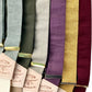 Rustic linen suspenders in fall tones: sage, olive green, soft gray, vintage plum, marigold gold, and deep Bordeaux with gold hardware.
