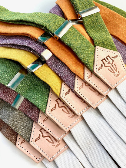 Bold fall women’s linen suspenders with magnetic leather clasps, featuring olive, mustard, and rustic colors.