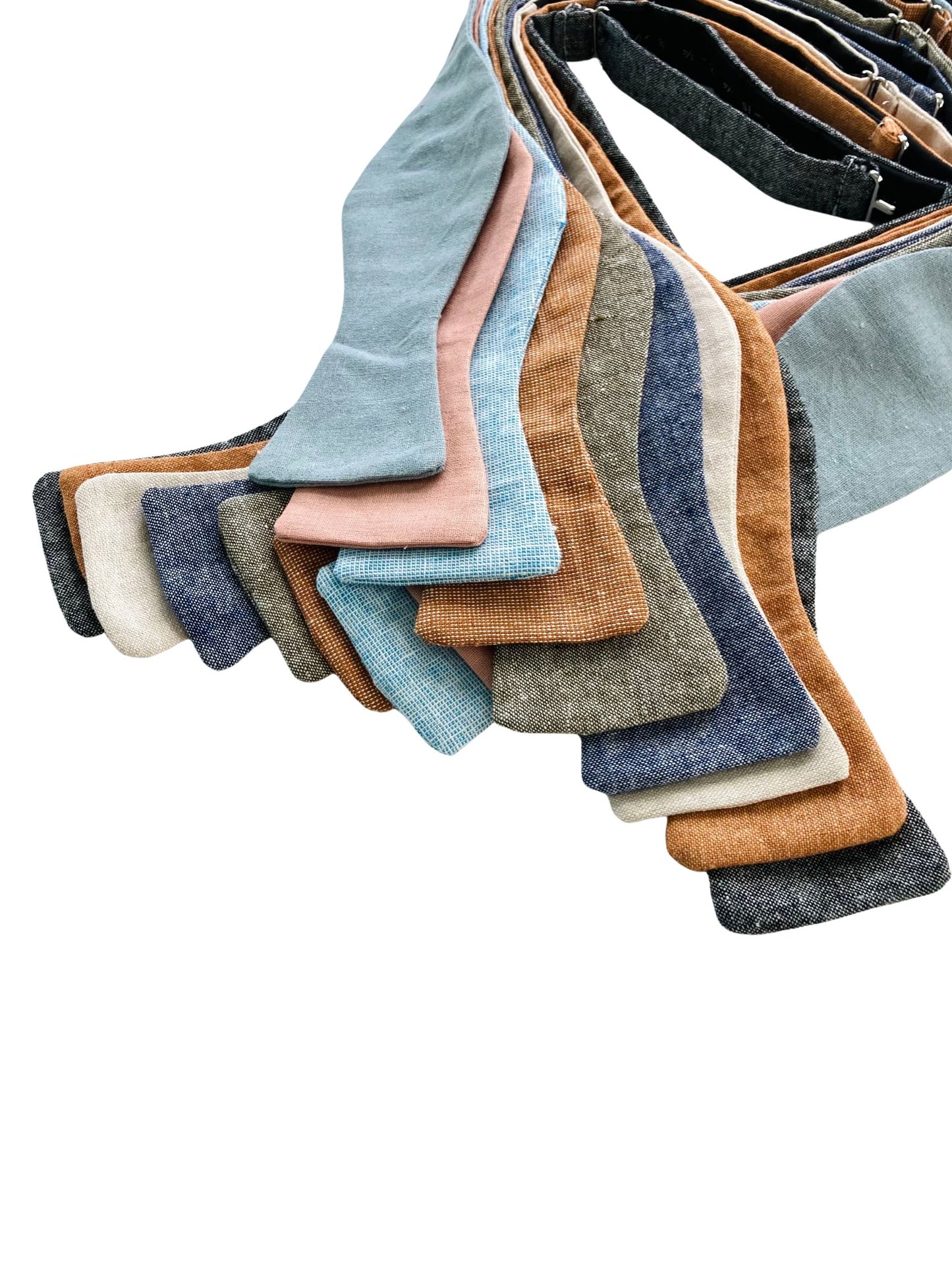 Close-up of fine linen self-tie bow ties in rich, earthy tones, showcasing detailed fabric texture and premium wedding colors for groomsmen and formalwear.