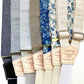 A lineup of handmade linen suspenders in floral and neutral tones, featuring Stratton Suspender Co. leather patches and metal adjusters—perfect for rustic weddings, groomsmen gifts, or heirloom menswear made in Texas.