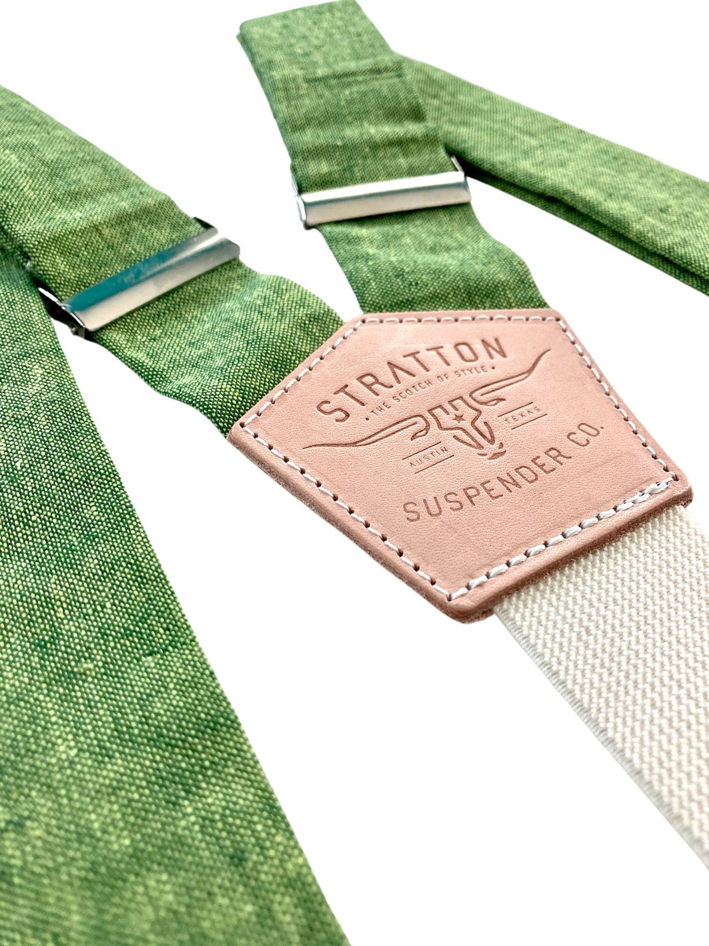 Close-up of Forest Green Magnetic Clasp Suspenders with full-grain leather back patch, featuring Stratton Suspender Co. logo. Handmade in Texas, crafted for weddings and formal menswear.