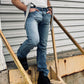 Gray linen button-on suspenders with black full-grain leather tabs, styled with vintage denim jeans, black leather boots, and a white heritage tee. Handmade by Stratton Suspender Co. for rustic wedding style and classic American workwear.