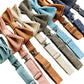 Close-up of handmade linen pre-tied wedding bow ties in assorted colors with premium silver-toned clasps, perfect for groomsmen, formal events, or men’s dresswear. Includes dusty rose, powder blue, beige, olive, roasted pecan, burnt orange, denim blue, and black.