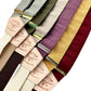 Linen suspenders in earthy and jewel tones including burgundy, gold, plum, and sage, styled for weddings, groomsmen accessories, and vintage formalwear.