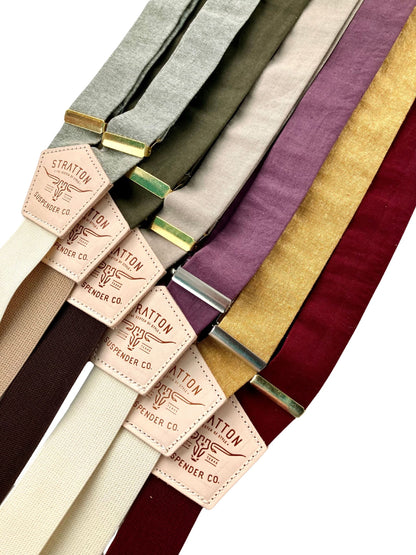 Linen suspenders in earthy and jewel tones including burgundy, gold, plum, and sage, styled for weddings, groomsmen accessories, and vintage formalwear.
