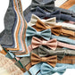 Stratton Suspender Co. collection of linen wedding suspenders and matching bow ties in powder blue, dusty rose, olive, burnt orange, ivory beige, vintage black, and dusty blue.