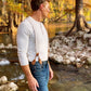 Man wearing Magnetic Clasp Suspenders with Beige Linen Straps, styled with a Henley shirt and denim in a rugged outdoor setting. A perfect blend of heritage craftsmanship and modern menswear.