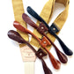 Close-up of rustic marigold suspenders with interchangeable leather tabs in black and brown tones—perfect for custom groomsmen wedding orders.