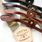 Neutral linen suspenders in mushroom with four premium leather attachment options, shown with gold adjusters.